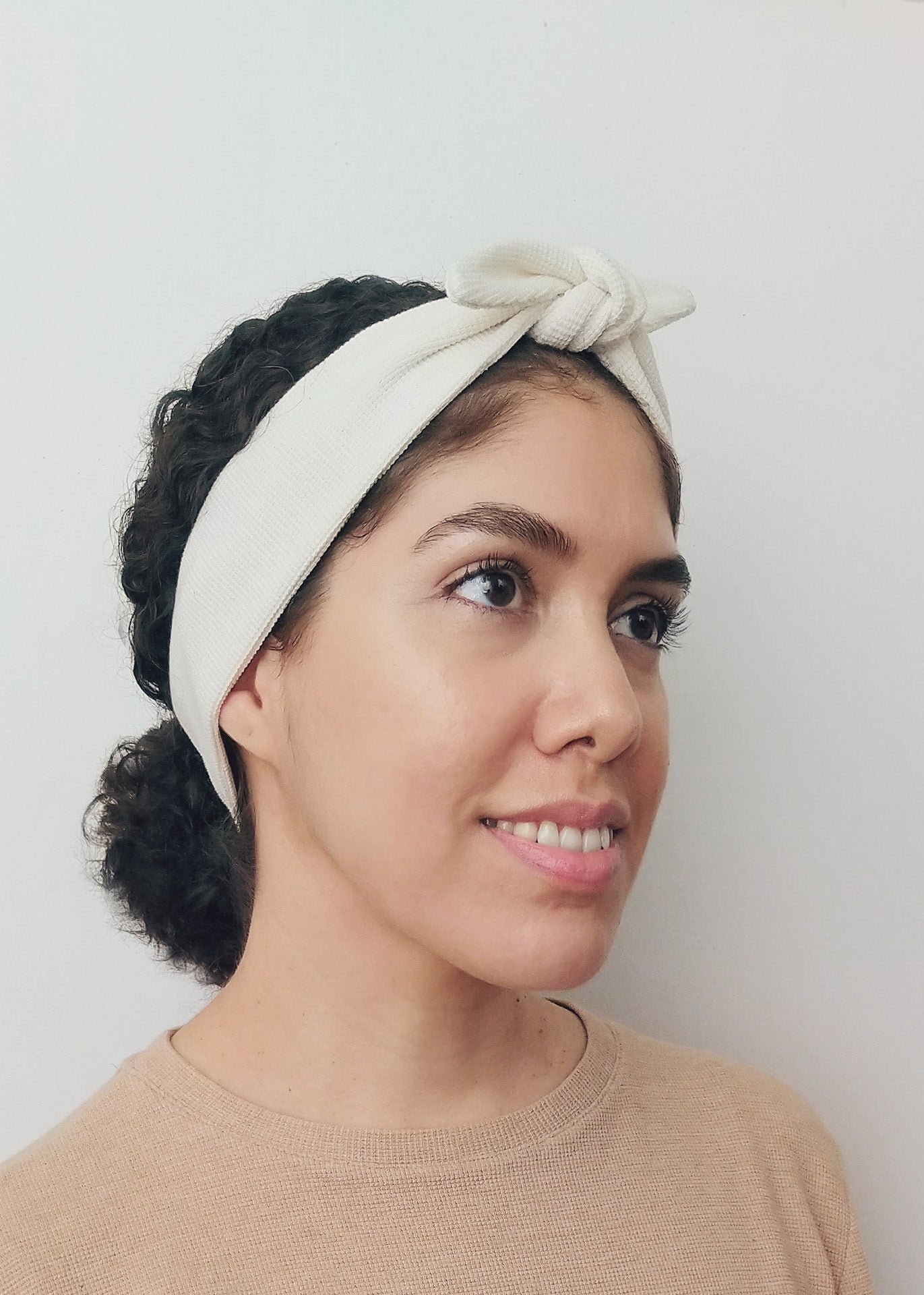 Woman wearing an ivory organic cotton headband