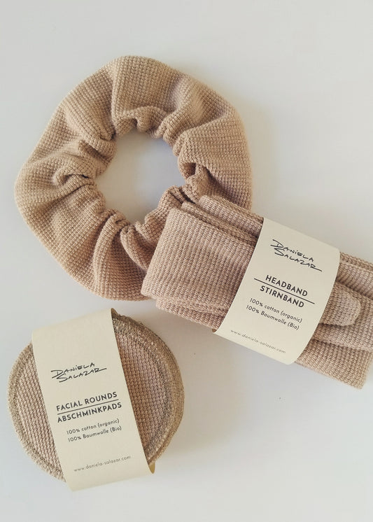 a headband, reusable face pads and a scrunchie. All of the made in light brown organic cotton
